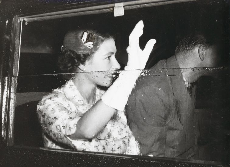 Black and white photo of The Queen visiting Lismore in 1954, waving from her car