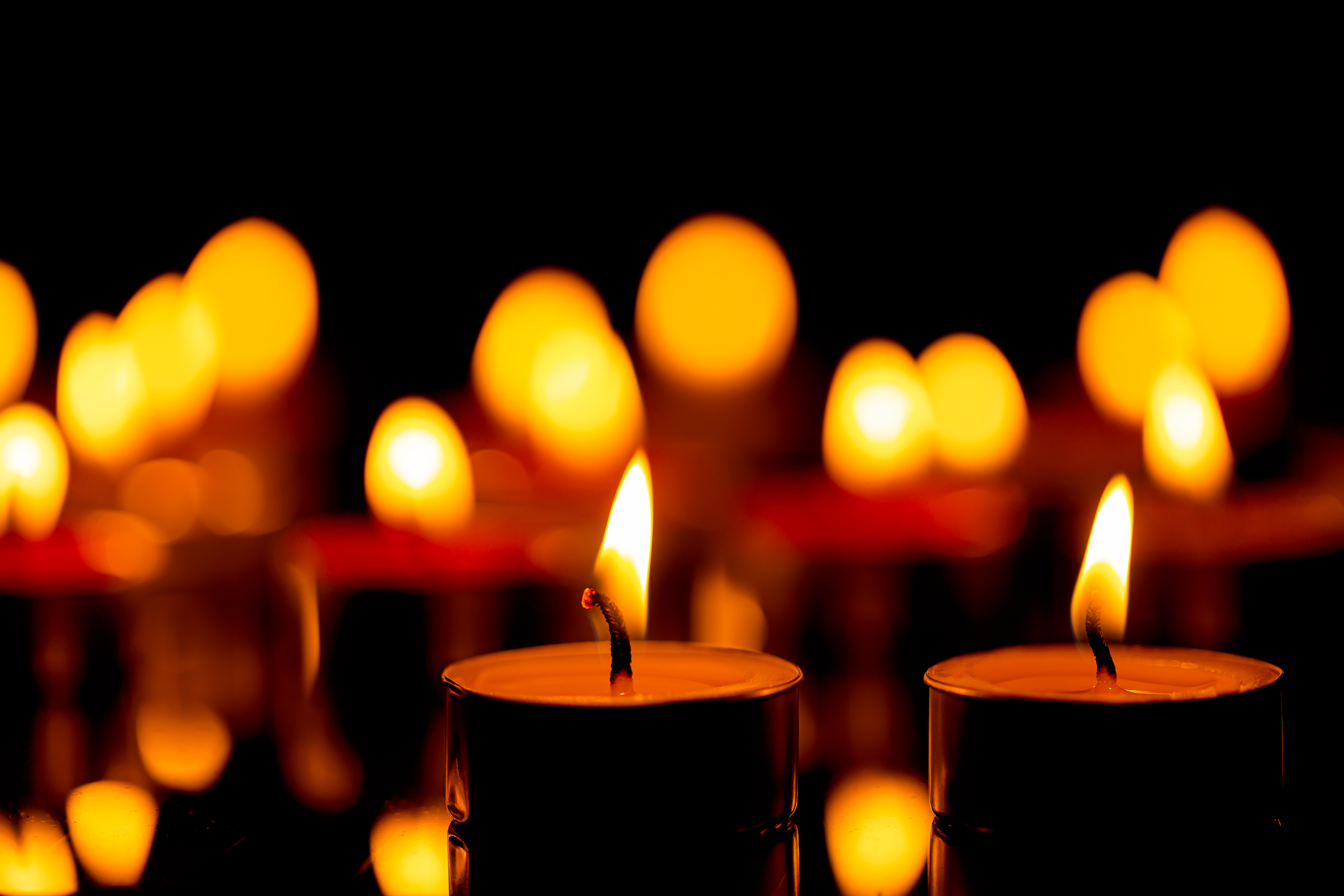 Closeup of burning candles in a dark room