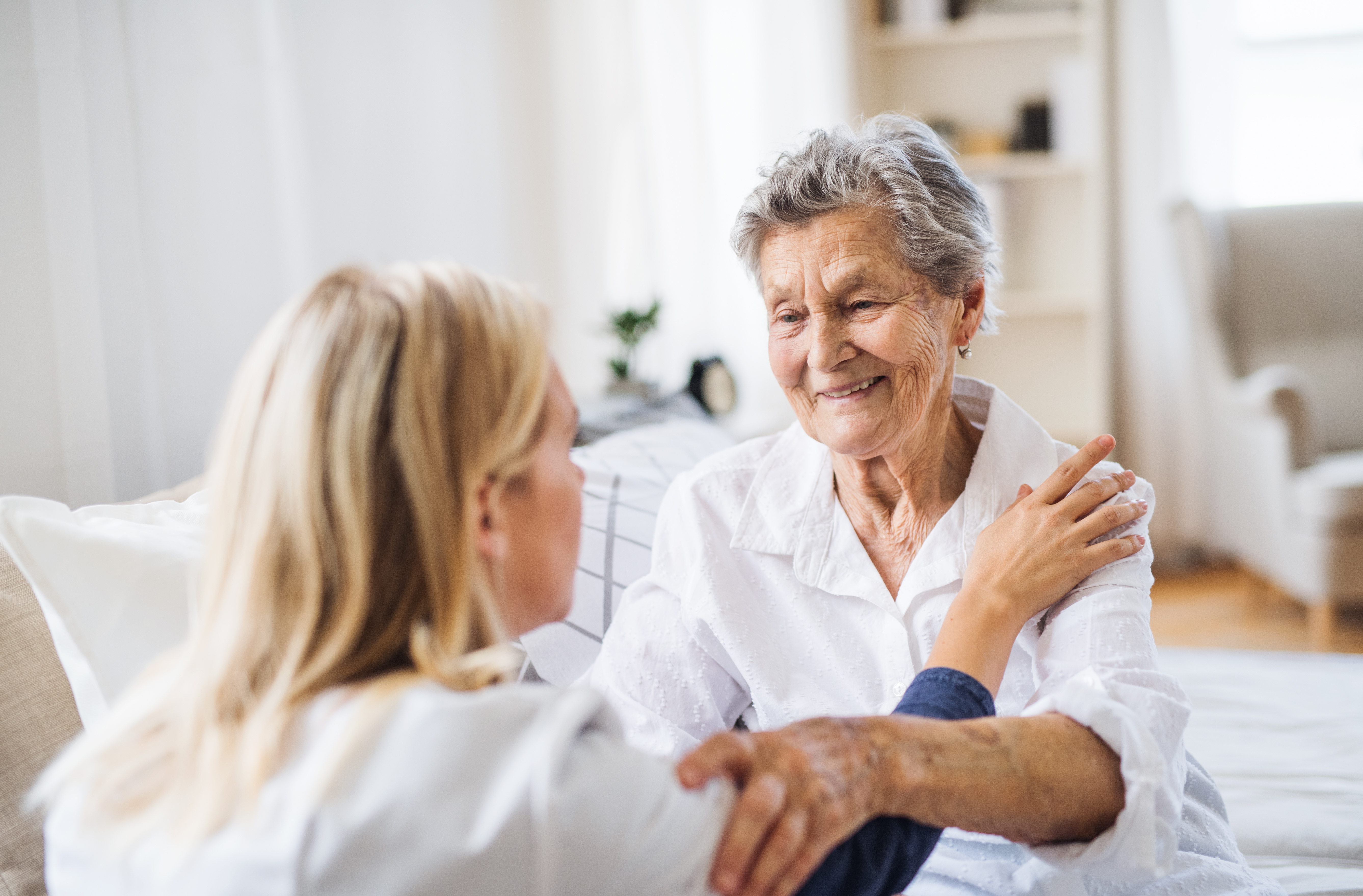 A health care person talking to a senior woman 