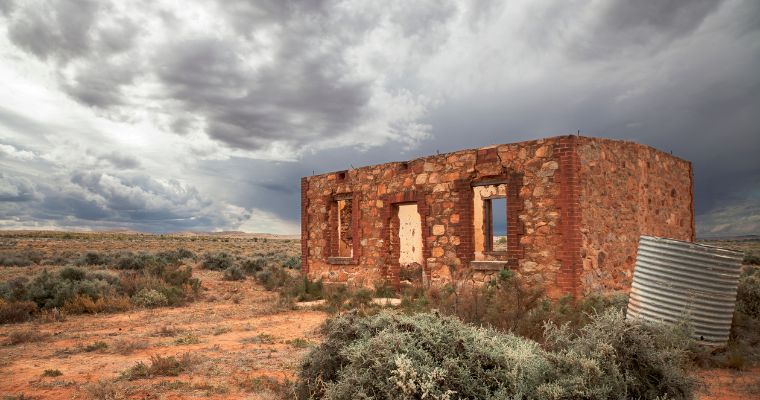 Heritage building eroding with moody clouds in background in 'middle of nowhere' Australia.