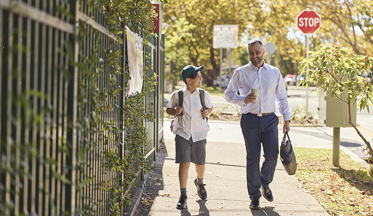 Boy walking to school with his dad