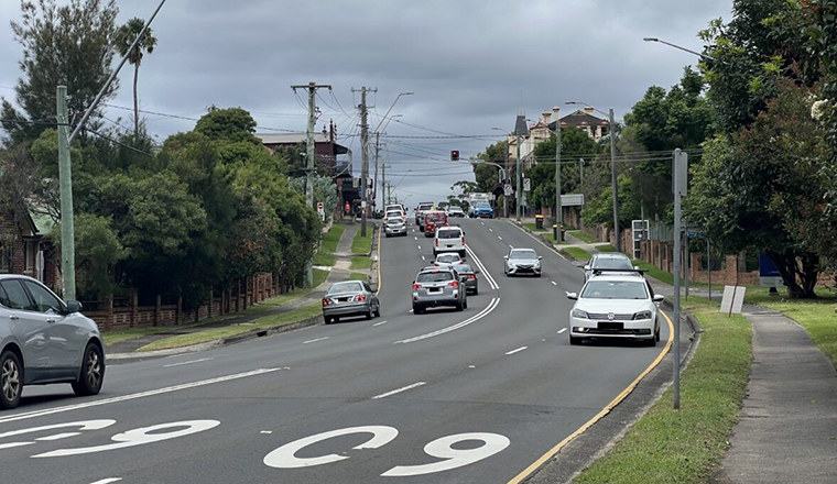 Cars on the road at the Bulli bypass on a cloudy day with trees on either side road