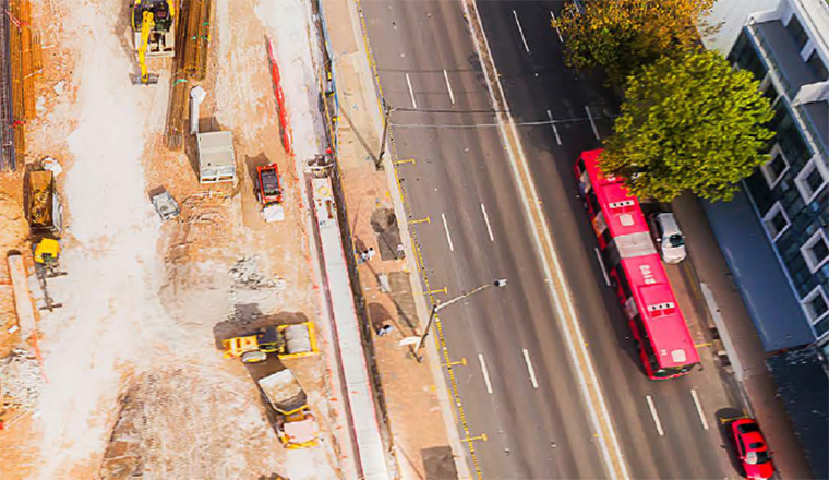 Contruction site and red bus and birds eye view