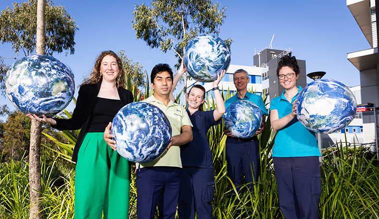 Health staff holding earth globes