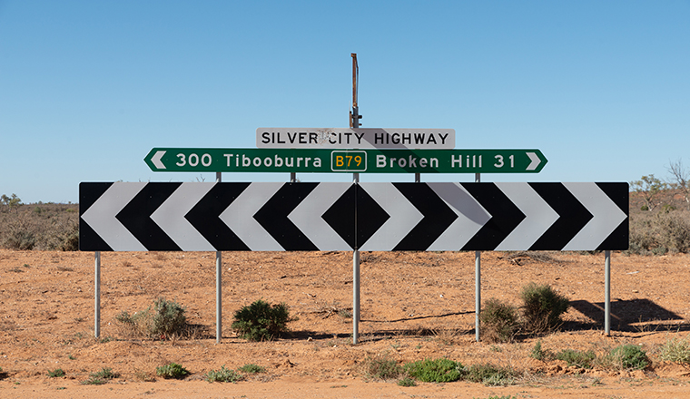 road signs pointing in opposite directions for Broken Hill to Tibooburra