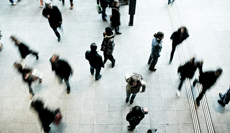 Aerial view of people walking on a busy city sidewalk.