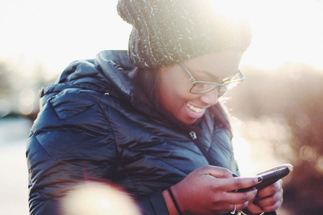 Young girl looks at her phone