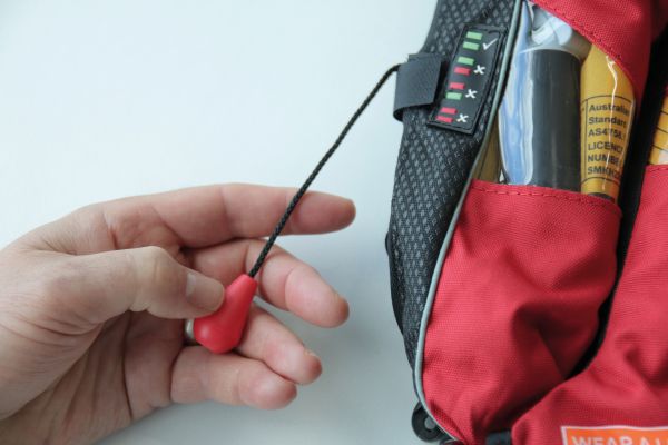Lifejacket user repacking lifejacket with pull cord free