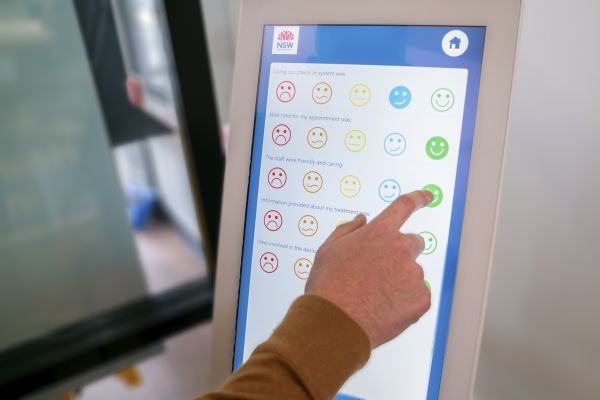 Closeup photo of a hand choosing feedback options on a tablet device screen