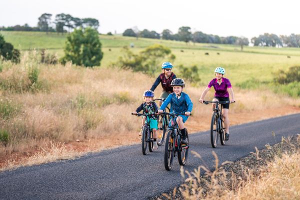Family on bicycles on country NSW road