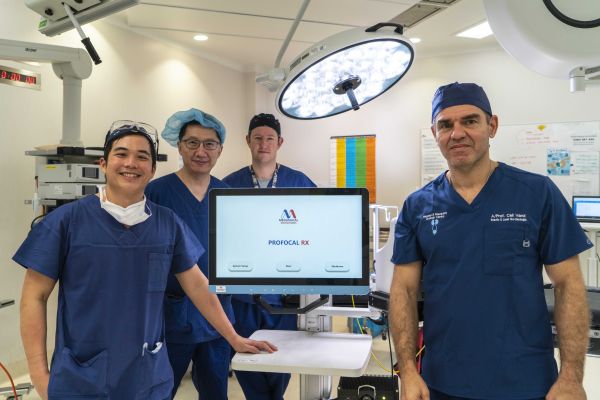Four doctors and a mobile computer in a clinical room