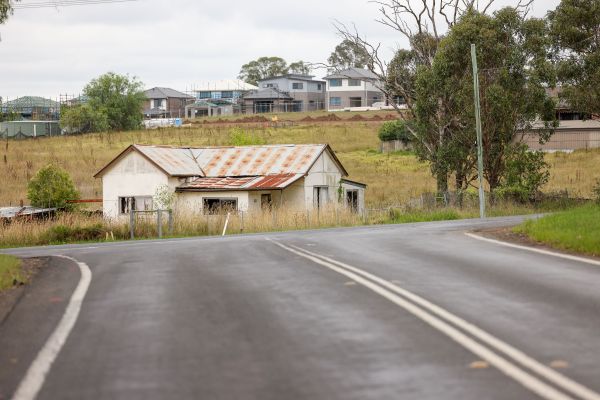 New homes under construction in Regional NSW with road and old house in the foreground