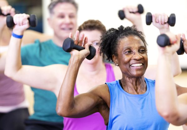 Senior woman exercising in group fitness class