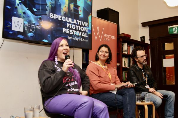 3 writers speaking at a Writing NSW festival to a crowd.