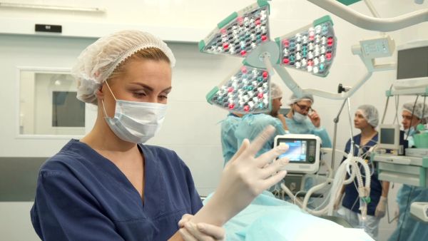 Person putting on gloves in operating room