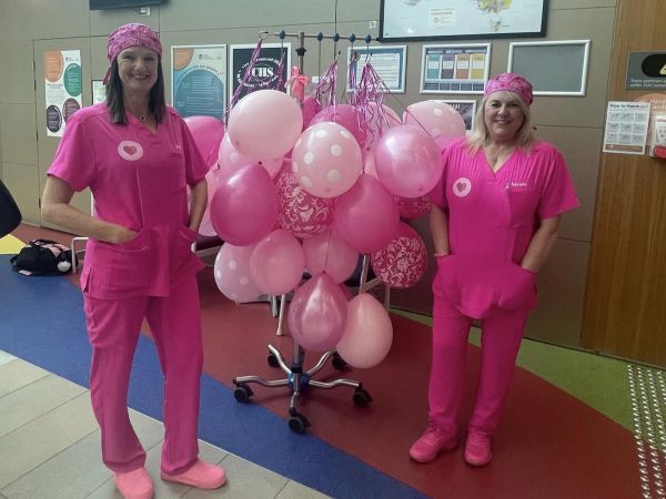 Two Bathurst nurses showing off pink scrubs at the hospital