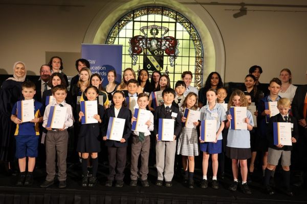 Group shot of children with certificates, winners of the 2023 literary award