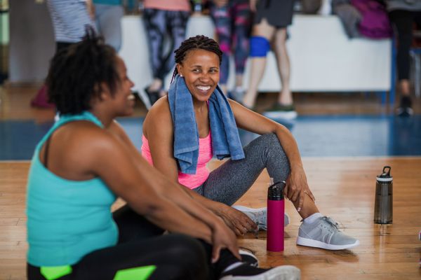 Two women talking after a fitness class