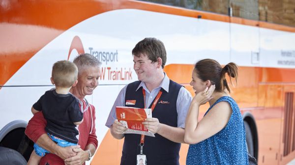 NSW TrainLink employee helping happy regional customers
