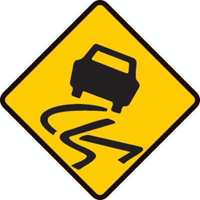 Warning slippery when wet sign. Slow down and drive to conditions