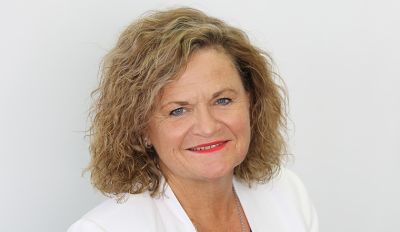 An image of Minister Wendy Tuckerman wearing a white blazer on a white/grey background.