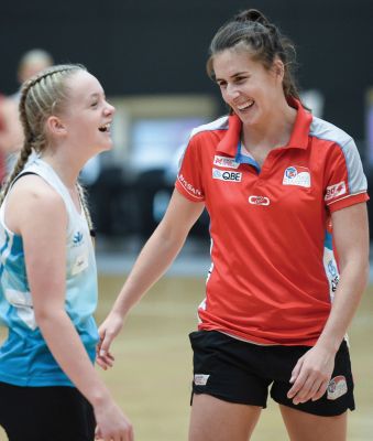 Coach with young netball player