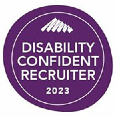 A white triangle squiggle and the words Disability Confident Recruiter 2023 sit on top a purple circle with a white ring around it