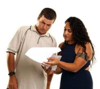 Image of lady showing a man how to read a document 