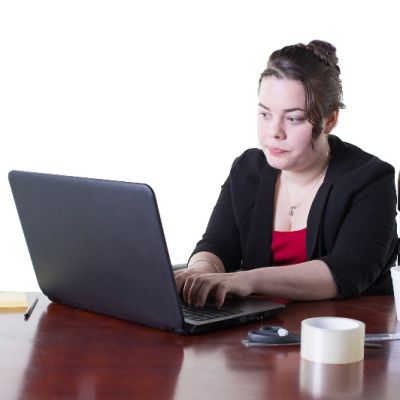 Image of person typing on a laptop