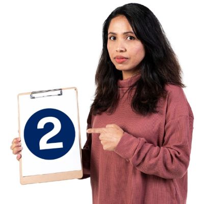 Image of person holding a sign and pointing to the number two  