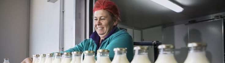 A woman working in a milk bottling factory at the Little Big Dairy Co in Dubbo