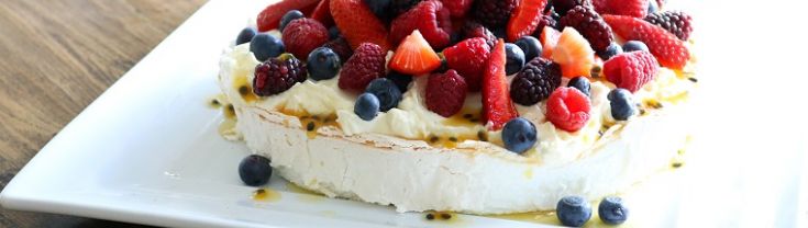 Pavlova dessert topped with berries