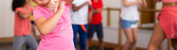 A group of young girls at a dance class