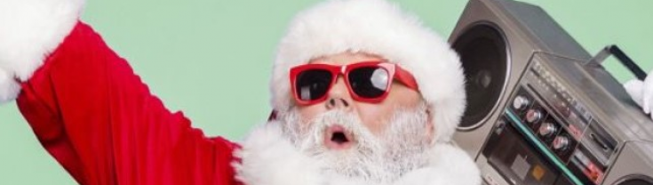 Person dressed in Santa suit with 'boom box' music player on shoulder