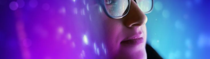 Image of lady in glasses with colorful futuristic lights around 