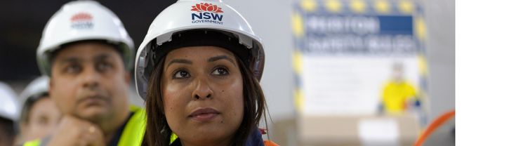A woman in a construction hard hat