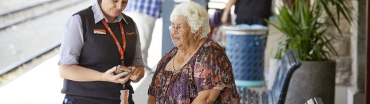 Older lady showing phone to Transport NSW staff