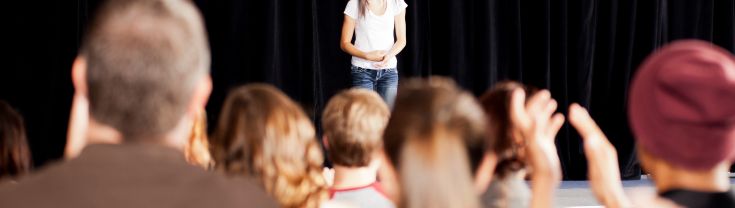 School student on stage in front of an audience