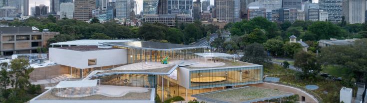 Roof of modern architecturally designed complex with Sydney cityscape in background