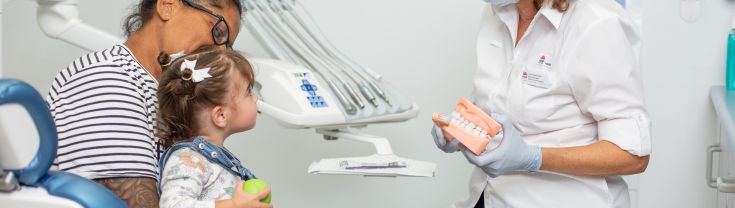 Dental Therapist talking to child and carer
