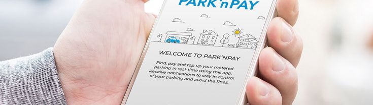 A person holds their smartphone in their hand, with the Park n Pay app open.