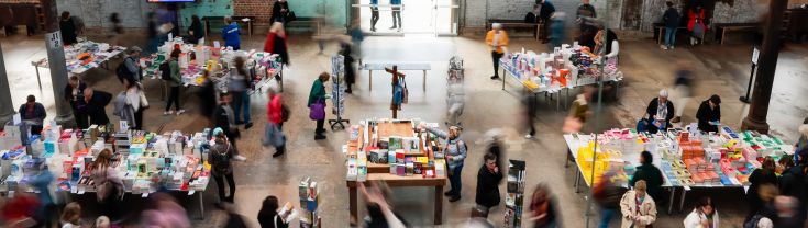 Birds eye view of books on tables in Carriageworks as part of Sydney Writers' Festival