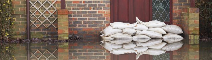 Sandbags laid against outside of front door to prevent water entering