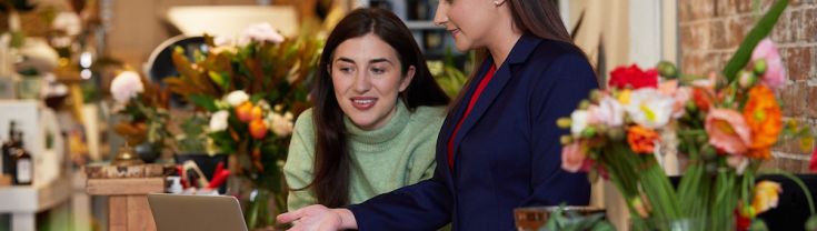 Two women having a discussion at a laptop