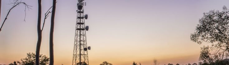 Communications and radio tower in a remote area at sunset