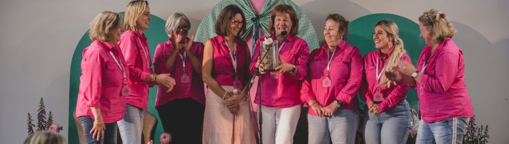 Group of women in pink shirts smiling