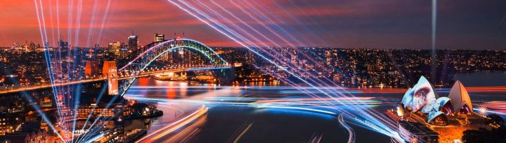 Watch the Sydney skyline light up in glowing colours from the comfort of a Vivid Sydney cruise.