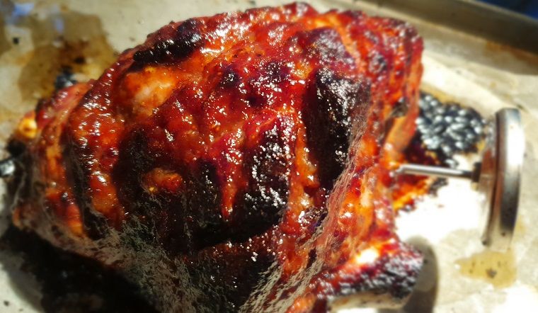 Cooked, glazed lamb roast with meat thermometer