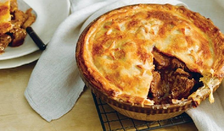 Cooked beef pie with slice taken