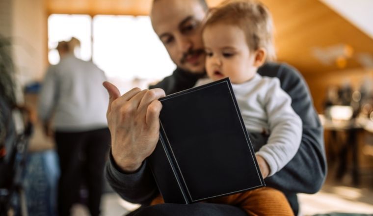 A father reading a book to his child